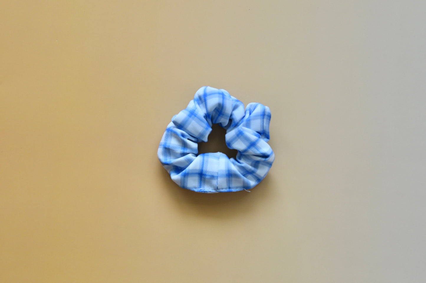 Blue scrunchie on a beige background