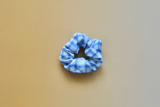 Blue scrunchie on a beige background