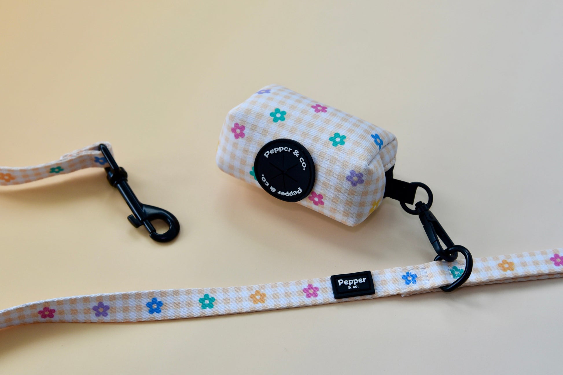 Dog leash and collar set with floral pattern on a light background