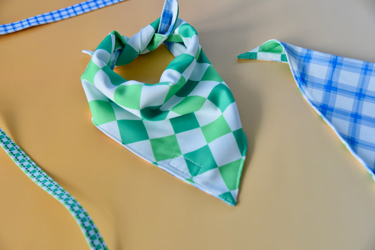 Green and white checkered bandana on a beige surface