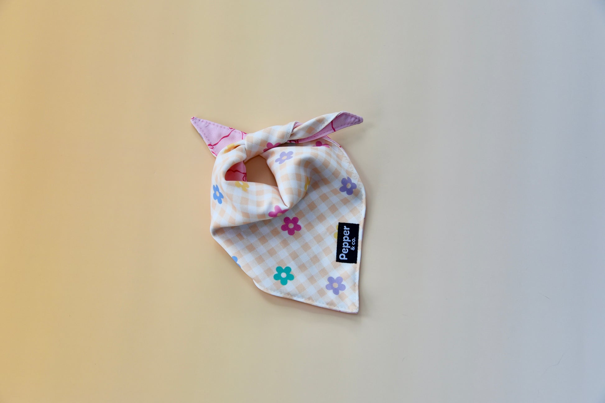 Dog bandana with floral pattern on a plain background